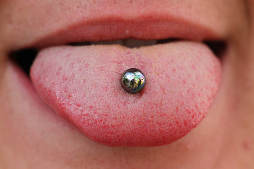 Patient showing tongue piercing before dental appointment at The Center for Esthetic Dentistry in Grants Pass, OR