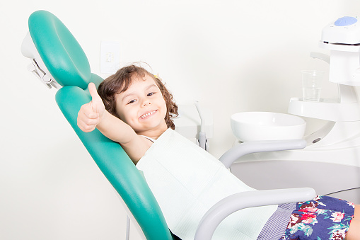 Smiling girl in a dental chair.