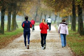 Image of people jogging on a path with trees near The Center for Esthetic Dentistry.